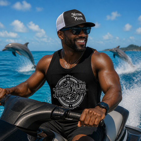 Man riding jet ski with dolphins jumping in background, wearing the SLC™ Nothing Major black tank top and matching trucker hat