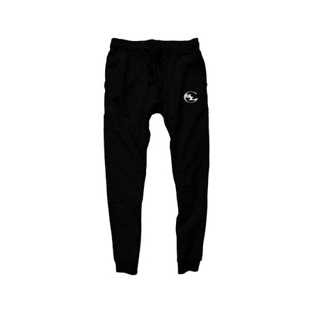 pair of black streetwear joggers by Something Light Clothing. The design features an elastic drawstring waistband and tapered legs with ribbed ankle cuffs. A white circular "SLC" monogram logo is prominently printed on the upper left thigh.