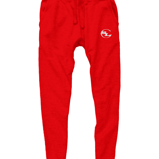 A pair of vibrant red joggers by Something Light Clothing. The pants feature a drawstring waistband and ribbed ankle cuffs. A white circular "SLC" monogram logo is printed on the upper left thigh.