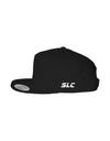 A black flat-brim snapback hat by Something Light Clothing. The front features a centered, white embroidered circular "SLC" monogram logo. An authentic "The Authentic Yupoong Snapback" silver sticker is visible on the top of the brim.