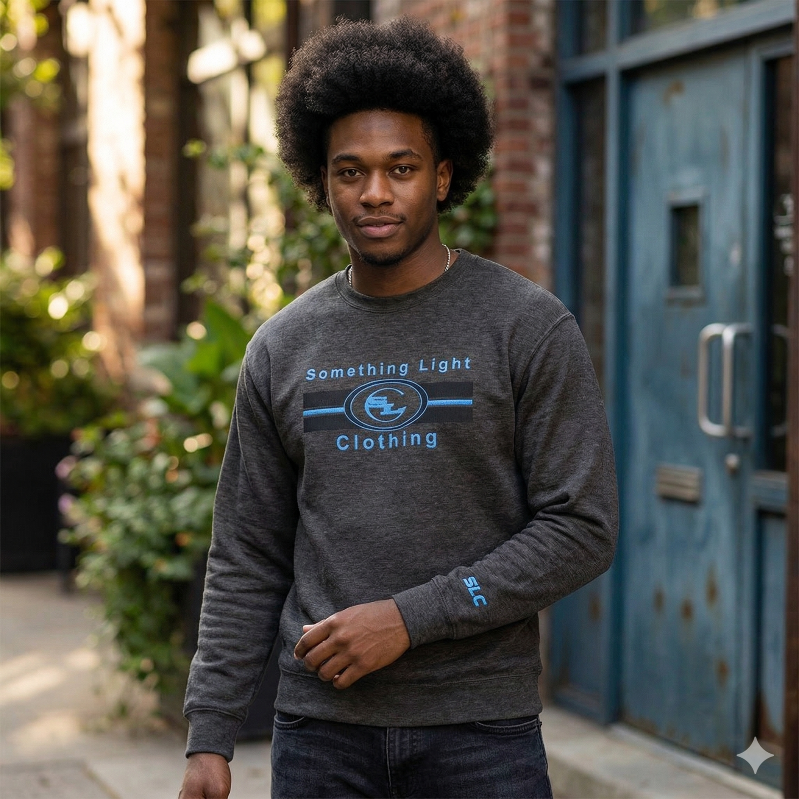 Gray chest logo sweatshirt from Something Light Clothing featuring a simple design and comfortable fit.